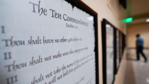 The Ten Commandments hangs on a wall.